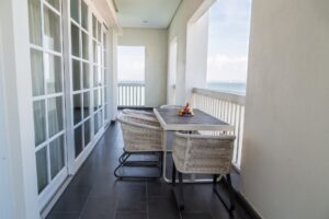 Relaxing balcony with table, chairs, fruits and with sea view