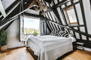 Stylish attic bedroom with a soft bed