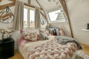 Wide bed in light attic bedroom
